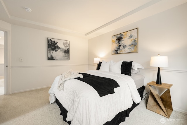 bedroom with baseboards, a raised ceiling, and carpet flooring