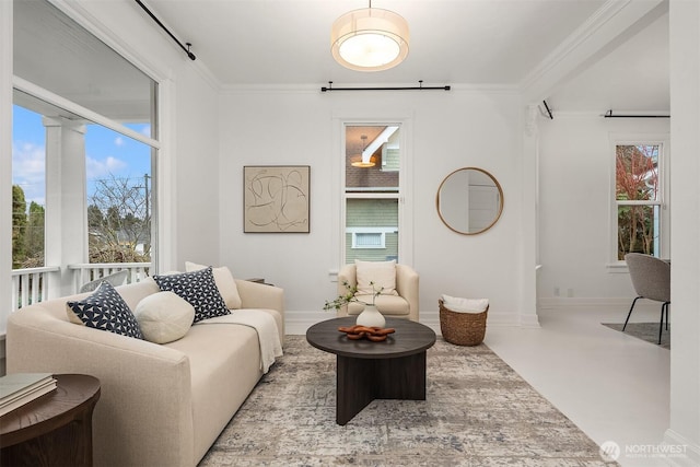 living room featuring baseboards and crown molding