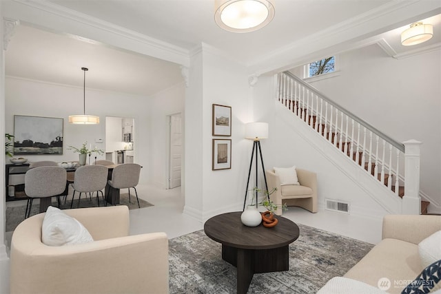 living area with visible vents, baseboards, ornamental molding, and stairway