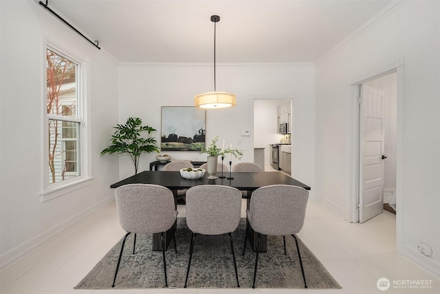 dining area featuring baseboards and crown molding