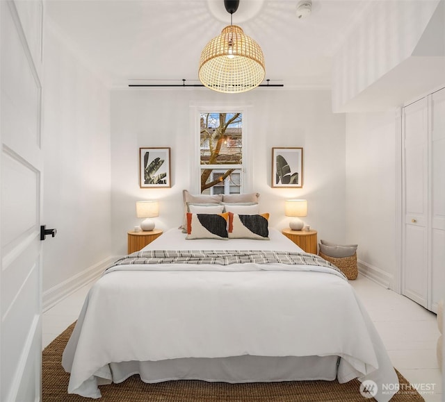 bedroom with crown molding and baseboards