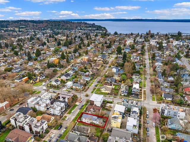 birds eye view of property with a water view and a residential view