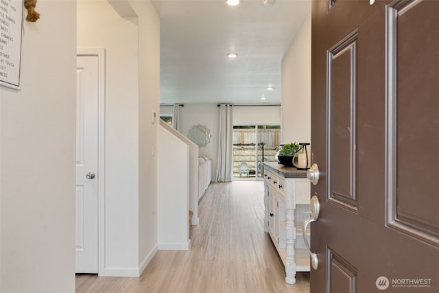 foyer entrance featuring recessed lighting, baseboards, and light wood finished floors