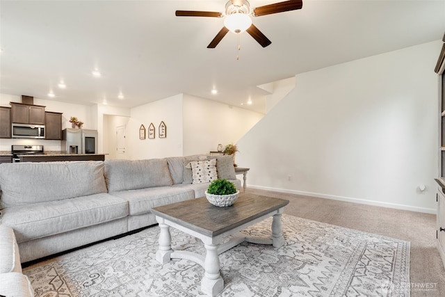 living area with recessed lighting, baseboards, light colored carpet, and ceiling fan