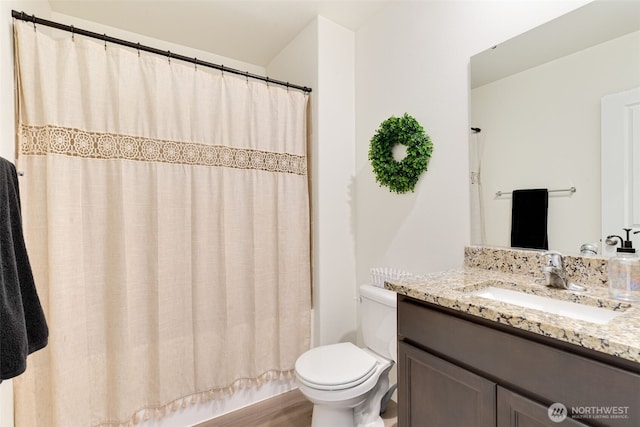 full bathroom featuring vanity, toilet, wood finished floors, and shower / bath combo