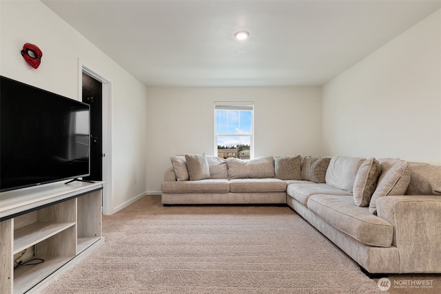 living room with baseboards and light colored carpet