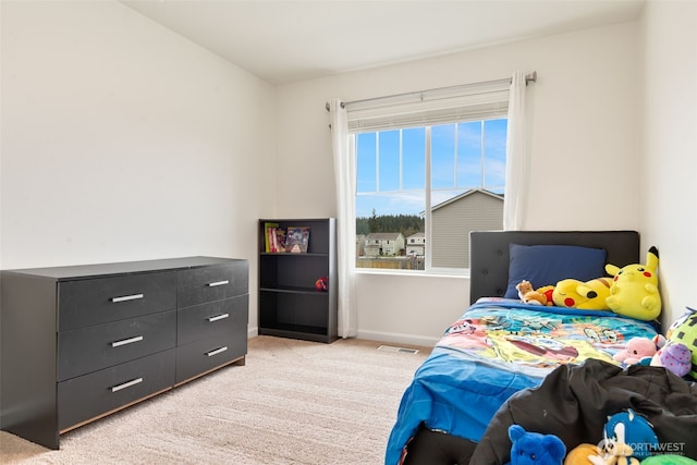 bedroom with visible vents, light colored carpet, and baseboards