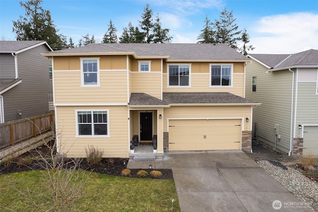 view of front of property with a garage, driveway, roof with shingles, and fence