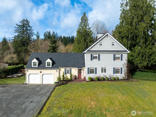 view of front of house with a front yard, an attached garage, driveway, and roof with shingles