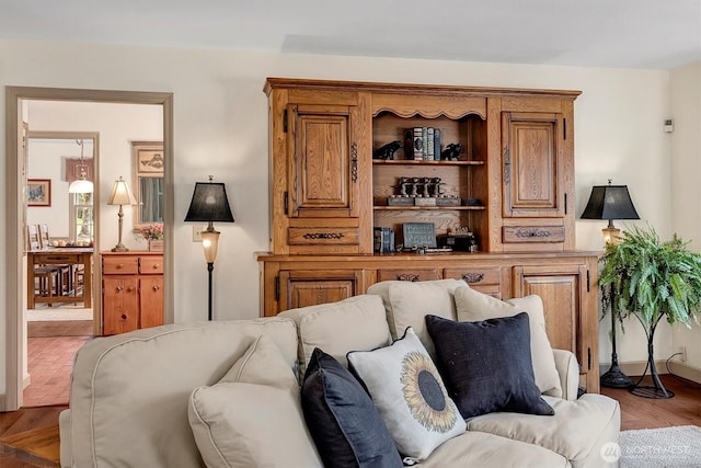 living area featuring baseboards and wood finished floors