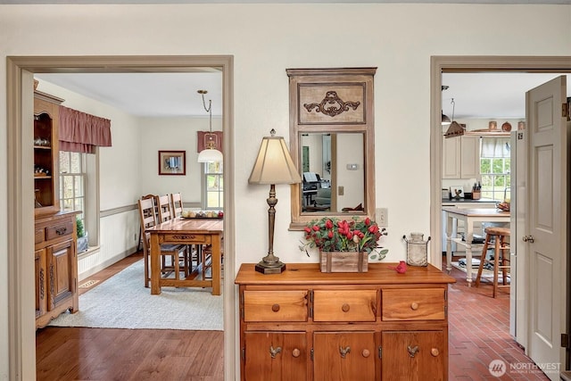 corridor featuring dark wood finished floors