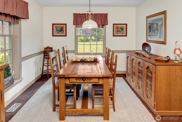 dining space with visible vents and wood finished floors