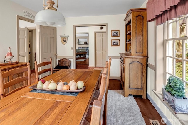 dining area with dark wood-style floors and visible vents