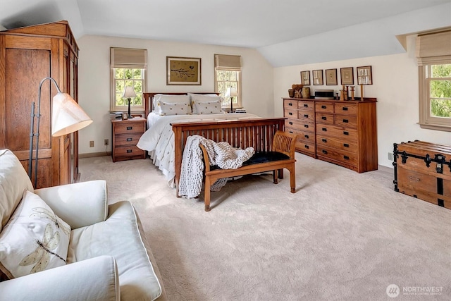 bedroom with lofted ceiling and light carpet