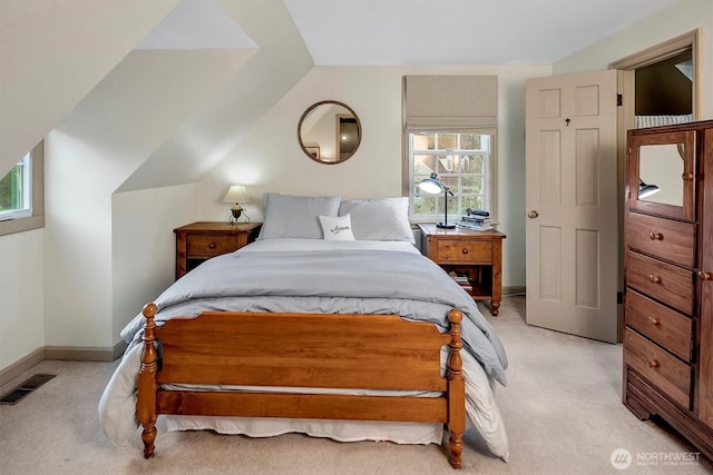 bedroom featuring visible vents, light carpet, baseboards, and vaulted ceiling