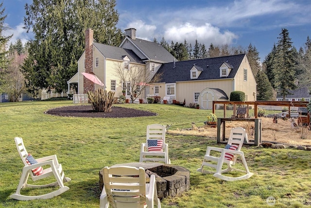 view of front of house featuring a front yard and an outdoor fire pit