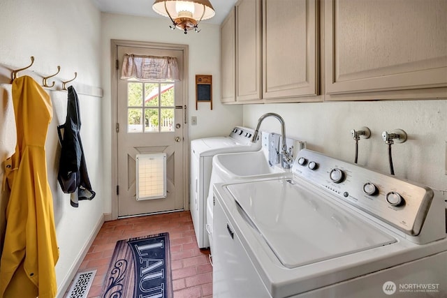 laundry area featuring washer and dryer, visible vents, cabinet space, and brick floor