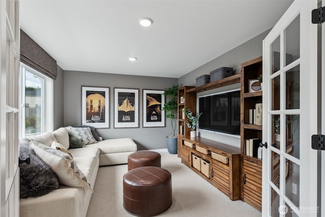 carpeted living area with french doors