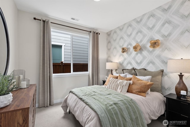 carpeted bedroom with visible vents and baseboards