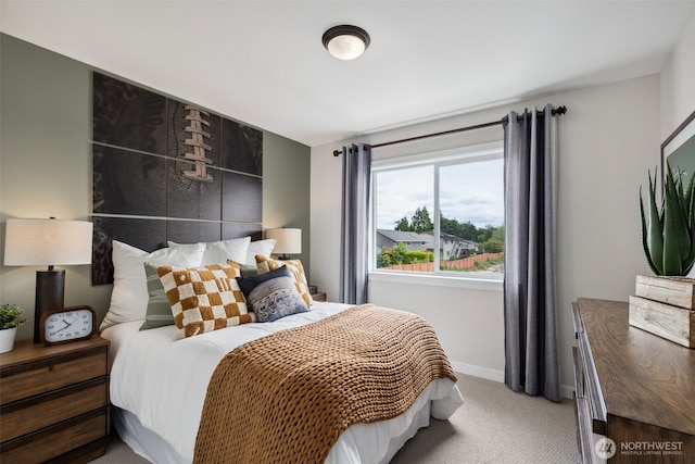 bedroom with light carpet and baseboards