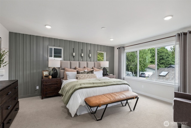 bedroom featuring baseboards and light colored carpet