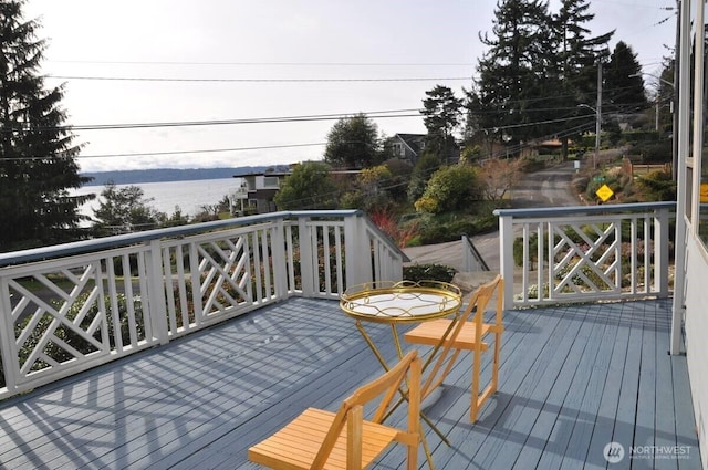 wooden deck featuring a water view