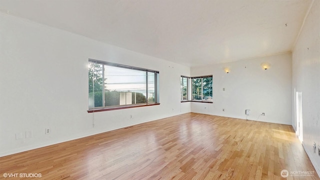 empty room featuring visible vents and light wood finished floors