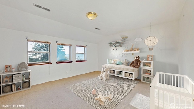 carpeted bedroom featuring visible vents