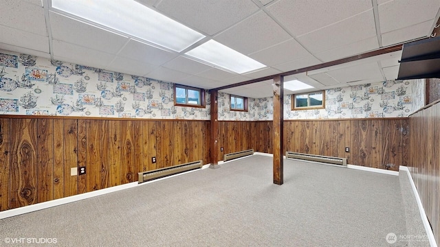 below grade area with a wainscoted wall and a baseboard radiator