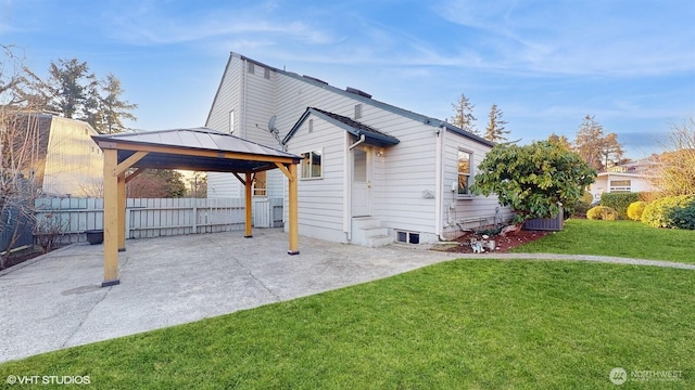 view of home's exterior featuring a gazebo, a patio, a yard, and fence