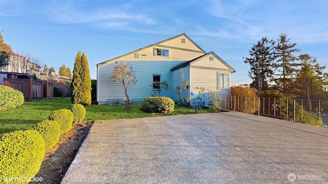 back of property featuring a yard and fence