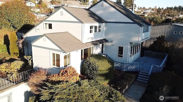 exterior space featuring a shingled roof