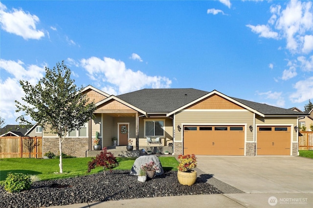 craftsman inspired home with stone siding, concrete driveway, a garage, and fence