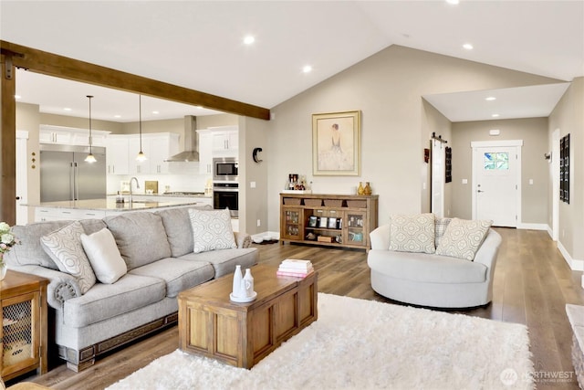 living area with vaulted ceiling, recessed lighting, wood finished floors, and baseboards