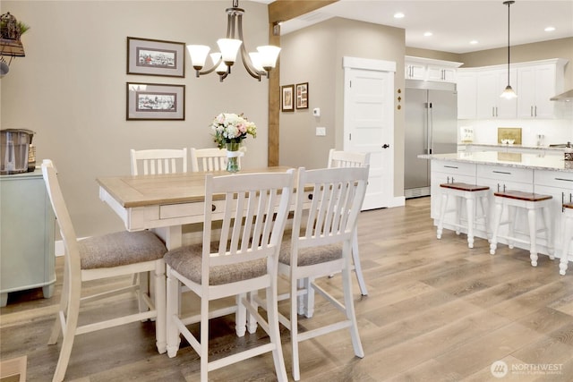 dining area with recessed lighting, a chandelier, and light wood-style flooring