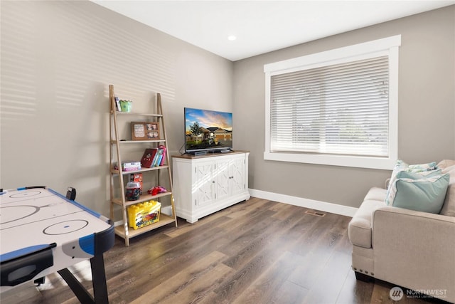 interior space with baseboards and wood finished floors