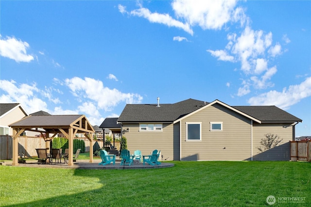 rear view of house with a gazebo, a yard, a fenced backyard, and a patio