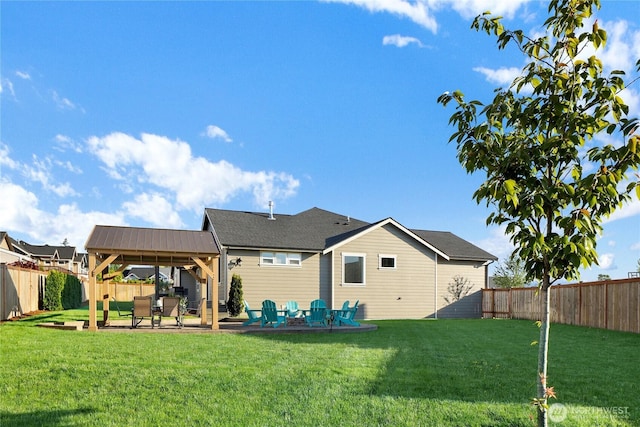 rear view of house featuring a gazebo, a yard, a patio, and a fenced backyard