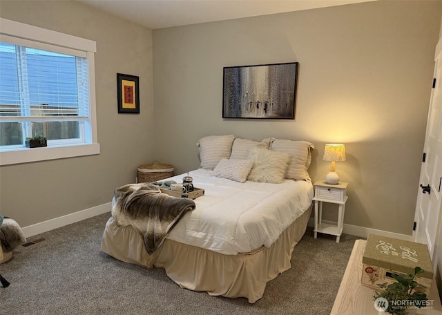 bedroom featuring visible vents, baseboards, and dark colored carpet