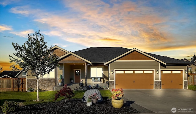 craftsman-style house with a garage, stone siding, driveway, and fence