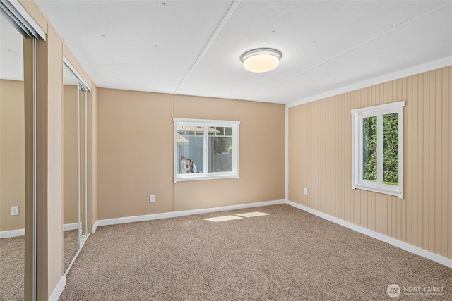 unfurnished bedroom featuring carpet flooring and baseboards