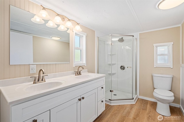 full bath with wood finished floors, a stall shower, and a sink