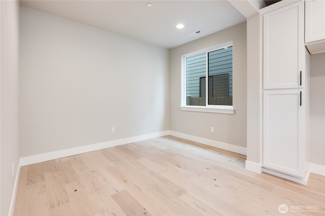 spare room with recessed lighting, visible vents, baseboards, and light wood-style floors