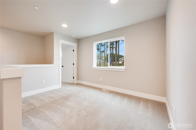 carpeted empty room with recessed lighting, visible vents, and baseboards