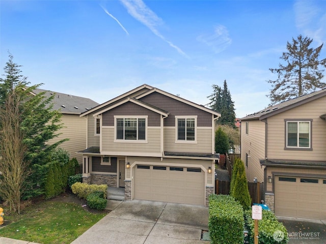 craftsman house featuring an attached garage, fence, stone siding, and driveway