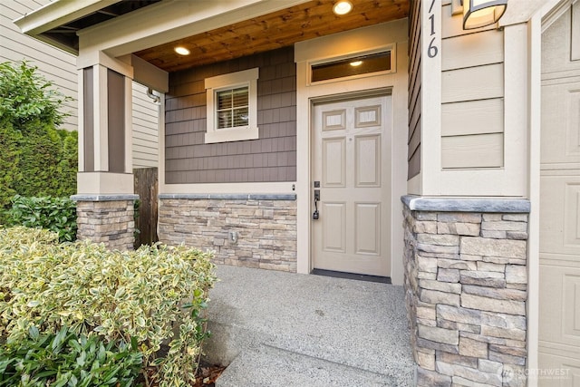 doorway to property featuring stone siding