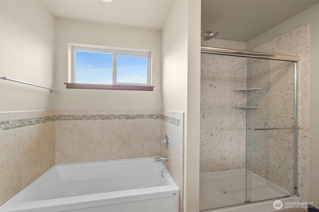 bathroom featuring a shower stall and a garden tub