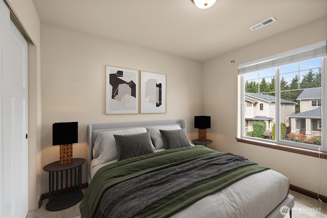 bedroom with baseboards, visible vents, and carpet floors