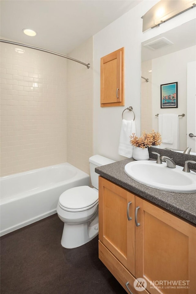 full bath featuring toilet, vanity, and shower / bathtub combination