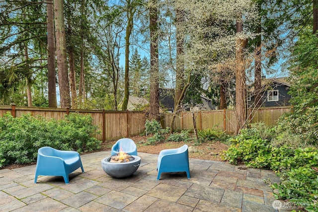 view of patio with a fenced backyard and an outdoor fire pit